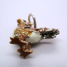 "This three-dimensional, sterling silver Rooster charm is hand-enameled and beautifully detailed. It features brown and black plumage, a white chest, tan neck, white head, black eyes, and a red cowl. Made by Brown County Silver. Vintage but in brand new, never worn condition. Charm height: 3/4\" high Charm height with ring: 1\" high Weight 4.2 grams See more @ https://www.etsy.com/shop/Brocosi" Brown County, White Chest, White Head, Sterling Silver Charms, Bird Charm, Food Jewelry, Black Eyes, Bird Jewelry, Cute Charms