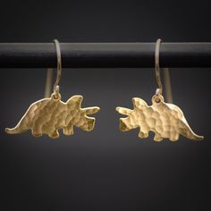 Gold Tiny Triceratops dinosaur dangle Earrings - where prehistoric charm meets modern elegance. Choose your style with the option of hammered gold for a textured, artisanal look or smooth gold for classic sophistication. These whimsical earrings feature a petite triceratops design, adding a playful touch to your ensemble.  perfectly combining the ancient and the chic for a distinctive fashion statement. ★Comes in our signature gift box, ready for gift giving.  ★ Available in Gold [ gold-filled e Whimsical Earrings, Dinosaur Jewelry, Jewelry Design Studio, Gold Skull, Goth Jewelry, Choose Your Style, Fan Earrings, Tiny Earrings, Hammered Gold