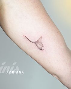 a small tattoo on the arm of a woman