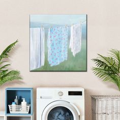 a washer and dryer in a room with towels hanging on the clothesline