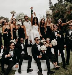 a group of people dressed in black and white posing for a photo