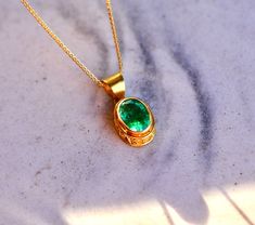 A stunning Zambian Emerald is set in a solid 18k gold setting with a patterned bezel. If you're looking for a gift for someone special, you can't go wrong with this. This pendant will absolutely stun her every time she looks in the mirror. Paired with a lovely 0.8mm 18k solid gold wheat chain it is hard to find a big stone as vibrant as this. Metal : 18kt Solid Gold  Size : 12.5x7.5mm   Gemstones : Natural Earth Mined Zambian Emerald Packaging : All products purchased from us come in a gift box. Elegant Cabochon Necklace For May Birthstone, Oval Bezel Setting Necklace For Anniversary, Luxury Oval Birthstone Jewelry, Exquisite Oval Engraved Jewelry, Elegant Formal Cabochon Emerald Necklace, Elegant Oval Pendant Jewelry With Bezel Setting, Luxury Oval Necklaces For May Birthstone, Oval May Birthstone Jewelry With Polished Finish, Luxury Oval Emerald Necklace For Anniversary