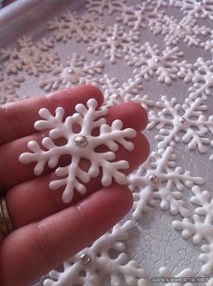 a person holding a white snowflake in their hand