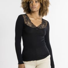 Style # 6839 Style: Ribbed Long Sleeve V-Neck Top w/ Leavers Lace Detail Fabric: 70% Merino Wool, 30% Silk. Made in Italy. Design: Long-sleeved ribbed top made of a precious and natural intimate blend of Merino Extra Fine Wool and top quality Silk, featuring a romantic and elegant Leavers Lace neckline. Rib knit fabric for an incredibly warm and soft feel and a perfect embrace on your body. Fit and Tips: Fitted. Figure-hugging.