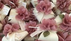 many pink flowers are on display in this close - up photo, with tags attached to them