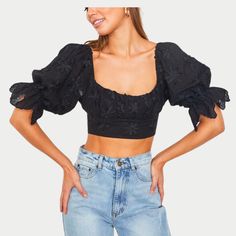 Dive into summer with the Jade Crop Top, where comfort meets refined style. This exquisite piece showcases delicate embroidery that elevates your casual wardrobe with a touch of sophistication. Designed with puff sleeves for a playful, voluminous look and a ruched front detail to flatter your silhouette, it's the epitome of elegance and fun. Trendy Summer Blouse With Gathered Sleeves, Trendy Summer Puff Sleeve Top With Balloon Sleeves, Summer Cropped Ruched Puff Sleeve Top, Ruched Cropped Puff Sleeve Top For Summer, Black Puff Sleeve Top For Summer, Summer Tops With Gathered Sleeves And Square Neck, Summer Ruched Puff Sleeve Top With Square Neck, Feminine Summer Tops With Gathered Sleeves, Summer Smocked Bodice Blouse With Lantern Sleeves