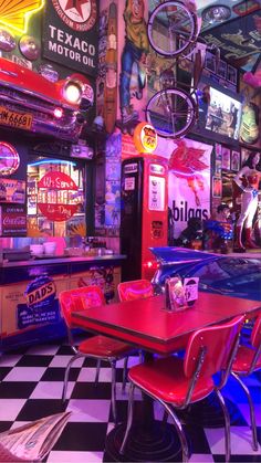 the interior of a diner with neon signs on the walls and checkered flooring