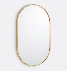 an oval shaped mirror with gold rims on the edge and bottom, against a white background