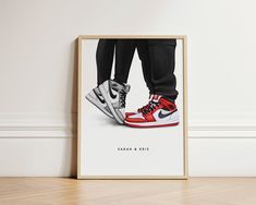 a framed photograph of a pair of sneakers on the floor with their feet up in the air