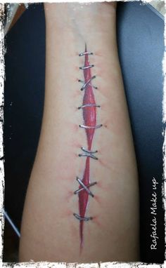 a tattoo on the back of a woman's arm with barbed wire attached to it