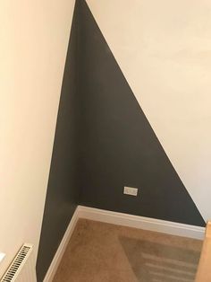 the corner of a room with a radiator and wall painted in black and white