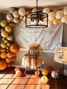 a room filled with balloons and a chair