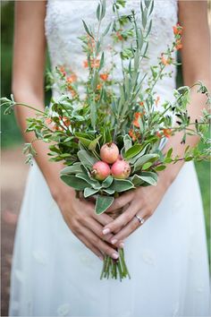 a woman holding a bouquet of flowers in her hands