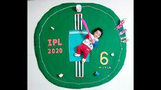 a child laying on top of a green clock