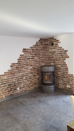 an empty room with a brick fireplace in it