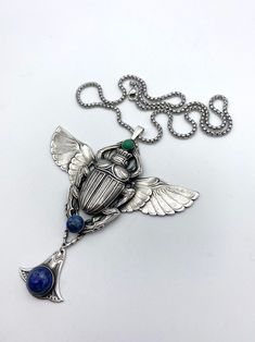 Nickel-free Silver Winged Jewelry, Collectible Silver Art Deco Jewelry, Art Deco Silver Metal Necklace, Art Deco Metal Pendant Jewelry, Elegant Winged Metal Jewelry, Winged Scarab, Revival Design, Old Factory, Egyptian Revival