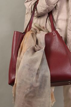 The full-grain pebbled calfskin Totona Tote is hand-made in Italy and features covered snaps, a four-way closure, a suede-lined interior with a zipper, and two easy-access pockets. Details Hand Made in Italy Italian Leather Made by Daniel&Bob Dimensions: 15 3/4" W X 13" H X 6" D Handle drop in 10" Product code: TOTONA HANDBAGS 549.38-2223 - WINE - OS Everyday Fall Bag With Pebbled Texture, Fall Pebbled Leather Bag With Leather Lining, Fall Shoulder Bag In Soft Pebbled Leather, Fall Travel Bag With Pebbled Texture, Luxury Brown Bag With Pebbled Texture, Luxury Brown Bags With Pebbled Texture, Elegant Pebbled Leather Shoulder Bag For Fall, Leather Shoulder Bag With Pebbled Texture, Brown Leather Shoulder Bag With Pebbled Texture