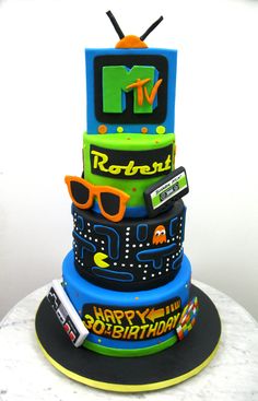 a multi layer cake decorated with an old tv and sunglasses on it's side