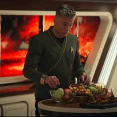 a man in uniform preparing food on a table