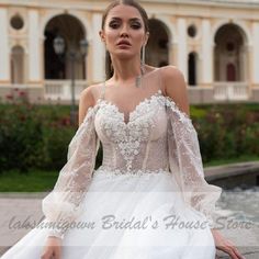 a woman in a wedding dress sitting on a ledge