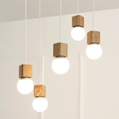 four wooden lights hanging from the ceiling in a room