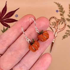 Handmade micro crochet pumpkin earrings! 🎃 each pair crafted by hand with top quality silver or gold hooks, for that perfect autumnal gift (whether for a loved one, or yourself!) 🌸 These special edition earrings come with sparkly gold detailing and a tiny leaf 🍃 I make these earrings to order by hand with waxed cotton thread and a 0.4mm crochet hook, finished with high quality earring hooks in a metal of your choice 💛 This item makes a perfect gift for lovers of autumn, fall, Halloween, cosy Handmade Halloween Earrings Gift, Handmade Sterling Silver Halloween Earrings, Handmade Dangle Jewelry For Fall, Handmade Jewelry For Fall Gift, Handmade Adjustable Jewelry For Fall, Adjustable Handmade Jewelry For Fall, Micro Crochet Earrings, Cottagecore Halloween, Cottagecore Accessories