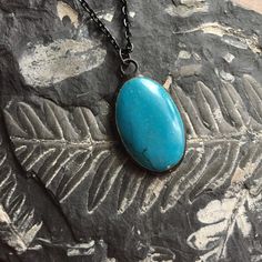 "Medium Oval Turquoise Howlite pendant necklace. Howlite: memory, creativity, patience. Artisan made hand-soldered with vintage finish.  Measures approx. 3/4\" x 1 1/4\" Chain has black finish and measures 24\" and has a lobster claw style clasp.   Cabochon is domed on the front and flat on the back. Reverse side shows the back of the stone.   All of my jewelry is made by me, expertly handcrafted and of heirloom quality.  I am the author of the bestselling jewelry books, Boho Chic Jewelry and Soldered Alchemy, and have been a jewelry artist for many years, so I have amassed quite a collection of unique stones. Please read the entire descriptions and view all photos before purchasing, as these sales are final. *Please note: props shown in photos are not included. This purchase is for the je Handmade Artisan Turquoise Oval Necklace, Handmade Artisan Oval Turquoise Necklace, Artisan Handmade Oval Turquoise Necklace, Handmade Spiritual Turquoise Necklace With Round Pendant, Artisan Turquoise Oval Necklace, Turquoise Necklace With Patina As A Gift, Unique Handmade Oval Turquoise Necklace, Handmade Unique Oval Turquoise Necklace, Artisan Turquoise Necklace With Oval Pendant