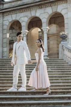 a man and woman are standing on some steps