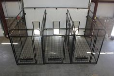 several cages are set up in the middle of a room