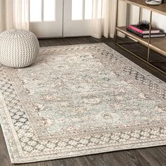 an area rug in a living room with wooden floors