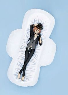 a woman laying on top of a cloud shaped pillow