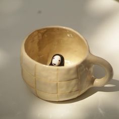 a ceramic cup with a penguin in it