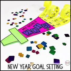 the new year goal setting is made out of colored paper and confetti pieces