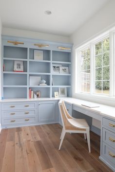 a chair sitting in front of a desk with bookshelves and drawers on it