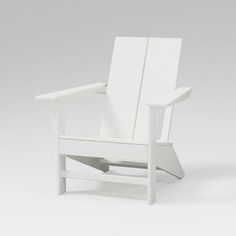 a white wooden chair sitting on top of a white floor