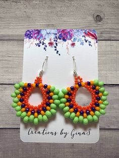 Handmade seed bead earrings. Bright and fun made with lime green, orange, yellow, and shiny purple seed beads, with a French ear wire hook. Vibrant Green Dangle Jewelry, Vibrant Green Dangle Earrings, Vibrant Green Earrings For Beach, Vibrant Handmade Green Jewelry, Green Teardrop Earrings With Tiny Beads, Vibrant Handmade Beaded Earrings For Summer, Green Beaded Earrings For The Beach, Green Teardrop Beaded Earrings With Tiny Beads, Colorful Green Beaded Earrings For The Beach