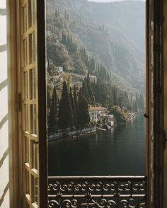 an open window looking out onto a lake