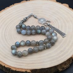 "Labradorite Gemstone Rosary, 33 Beads with 925 Sterling Silver Tassel, Turkish Prayer 33 Beads, Rosary, Tasbih, Tesbih, Tasbih, Sibha ✦ Details ✦ * Material: 925 Sterling Silver * Gemstone: Labradorite  * Bead : 33 Count * Bead Size: 10 mm * Silver weight: 13.10 grams * Total Length : 32 cm (12.60 Inches) * Length Without Tassel : 22 cm (8,66 Inches) ✦ Shipping ✦ * Processing time: 1-2 business days. * This item ships from my Turkish workshop in Istanbul. * Add your phone number in address box for a smoother delivery. That makes courier personnel's job easier.  ✦ Packaging ✦ * Comes with a luxury gift box and a jewellery cleaning cloth. ✦ Returns, Exchanges ✦ * Return option available for 30 days after the delivery. * The product has to be in the same shape, type, and material. * Personal Luxury Spiritual Silver Beads, Silver Beads, Gems, And Cabochons For Gifts, Silver Gemstone Beads And Cabochons, Silver Beads Gems And Cabochons For Gifts, Silver Gemstone Round Beads, Silver Rosary With Natural Stones For Gift, Silver Beads With Natural Stones For Jewelry Making, Silver Rosary With Natural Stones As A Gift, Silver Beaded Rosary For Meditation