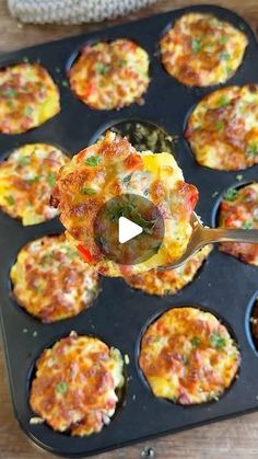 a muffin tin filled with mini frittatas on top of a wooden table