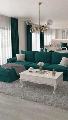 a living room filled with green couches and white tables