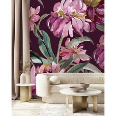 a living room scene with pink flowers on the wall and two tables in front of it