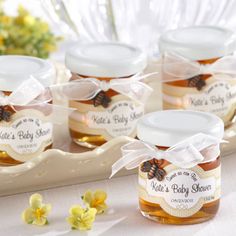 several jars filled with honey sitting on top of a table