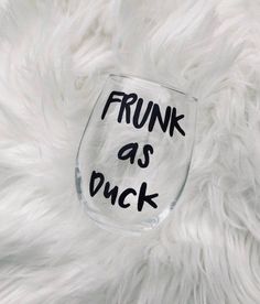 a wine glass with the words frunk as buck written on it in black ink