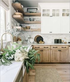 a kitchen with wooden cabinets and white marble counter tops