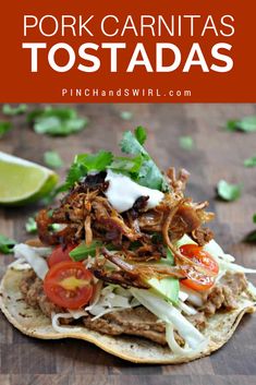 pork carnitas tostadas with tomatoes, lettuce and sour cream on top