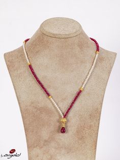 This exquisite handmade necklace features a stunning combination of ruby and freshwater pearl beads, strung together to create a piece that is both elegant and timeless. The lustrous pearls contrast beautifully with the deep red of the ruby, creating a unique and eye-catching piece of jewelry. Each bead has been carefully selected and handcrafted to ensure that this necklace is of the highest quality. This necklace is perfect for any occasion. It can be dressed up for a formal event or worn as a statement piece with a more casual outfit. Either way, this necklace is sure to make you stand out from the crowd and feel confident and beautiful. The combination of ruby and pearl is not only visually stunning but also has deep symbolic meaning. Ruby is said to represent passion and energy, while Elegant Red Pearl Necklace With Natural Stones, Elegant Red Necklace With Pearl Charm, Elegant Red Faceted Bead Pearl Necklace, Elegant Red Pearl Necklace With Faceted Beads, Elegant Ruby Necklaces With Natural Stones, Elegant Ruby Necklace With Natural Stones, Elegant Red Pearl Necklace With Gemstone Beads, Elegant Ruby Beaded Necklaces As Gift, Elegant Ruby Beaded Necklace Gift