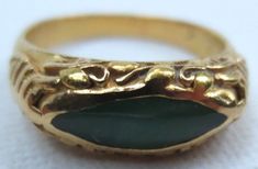 Offering for your consideration is this lovely vintage Chinese jadeite ring. Made of wonderful rich 22K gold. Interior is hallmarked 22K as well as the makers mark. Ring has been tested to ensure the metals purity. It is a size 6 1/4 and has a combined total weight of 4.8 grams. The sides have a Shou symbol which means longevity. Along the top is flowing vines and leaves. It proudly showcases a rich colored piece of Jadeite jade. It is natural A grade and free of any treatments. The eye shaped s Heirloom Gold Jade Ring, Heirloom Jade Ring In Gold, Heirloom Jade Rings In Yellow Gold, Heirloom Yellow Gold Jade Rings, Formal Gold Jade Rings, Victorian Style Gold Emerald Ring For Formal Occasions, Gold Engraved Emerald Ring For Formal Occasions, Saddle Ring, Pearl Rings Vintage