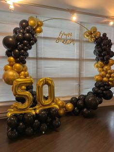 a 50th birthday decoration with balloons and streamers