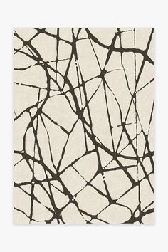 a black and white abstract painting with branches on the bottom half of it, against a neutral background