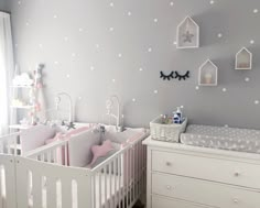 a baby's room with two cribs in it